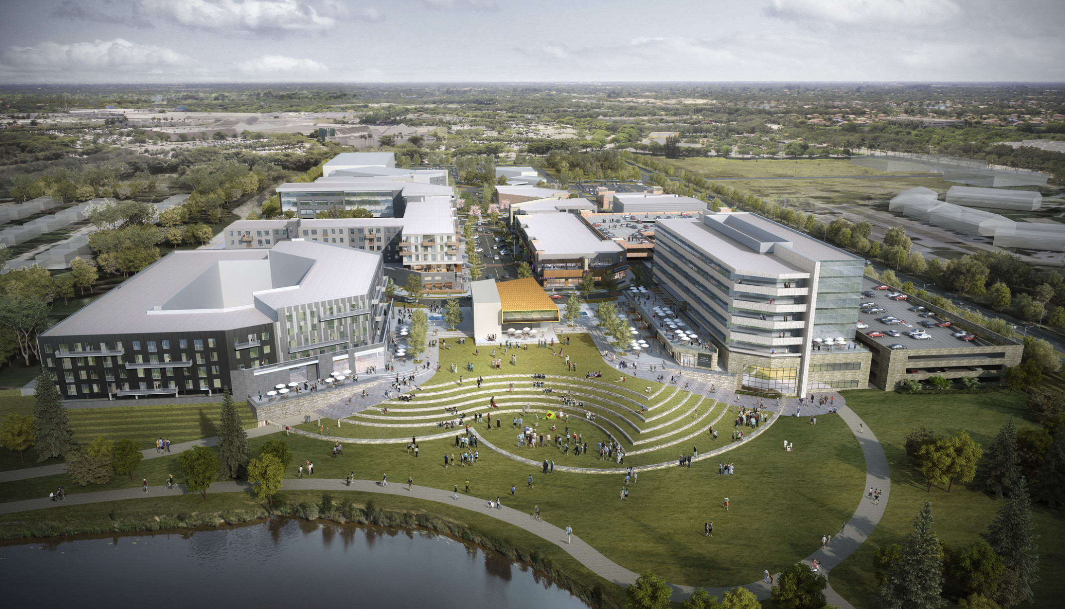 La Vista City Centre campus. Buildings line road and grassy central plaza with curving stepped landscape leading to water