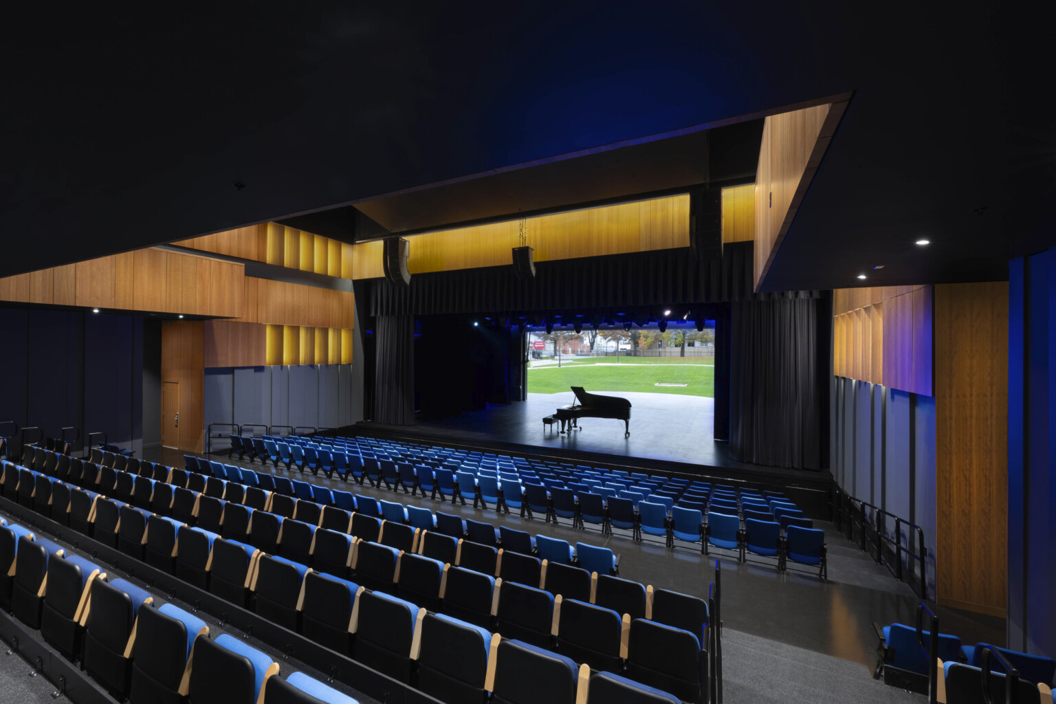 Indoor performance stage opens up to outdoor event lawn via large, retractable door