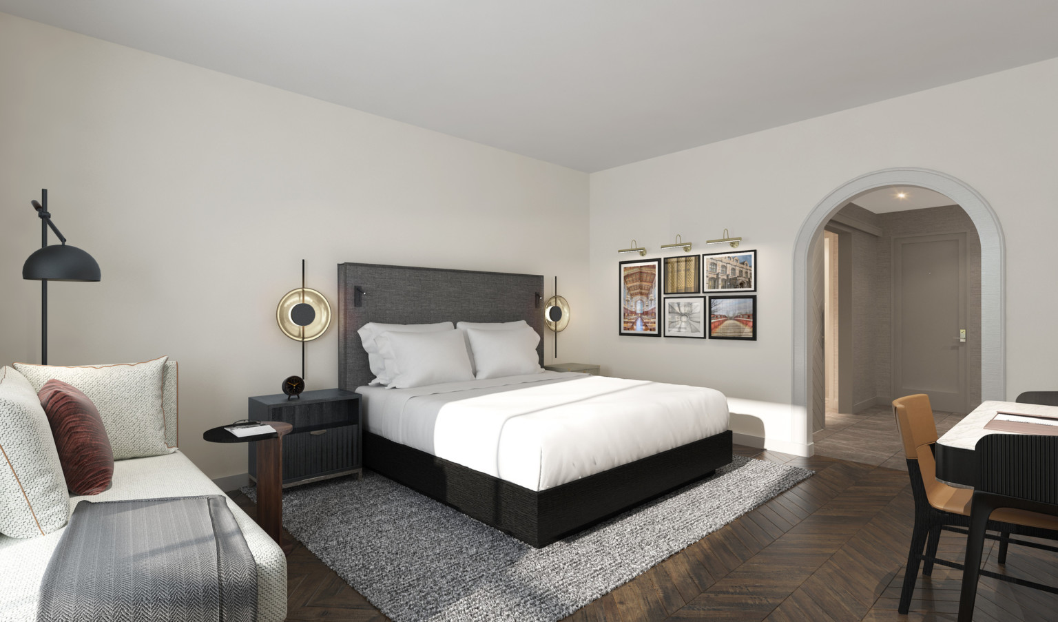 View of guest room facing hall, past bed with dark wood base, grey headboard with reading lights, and large round lamps