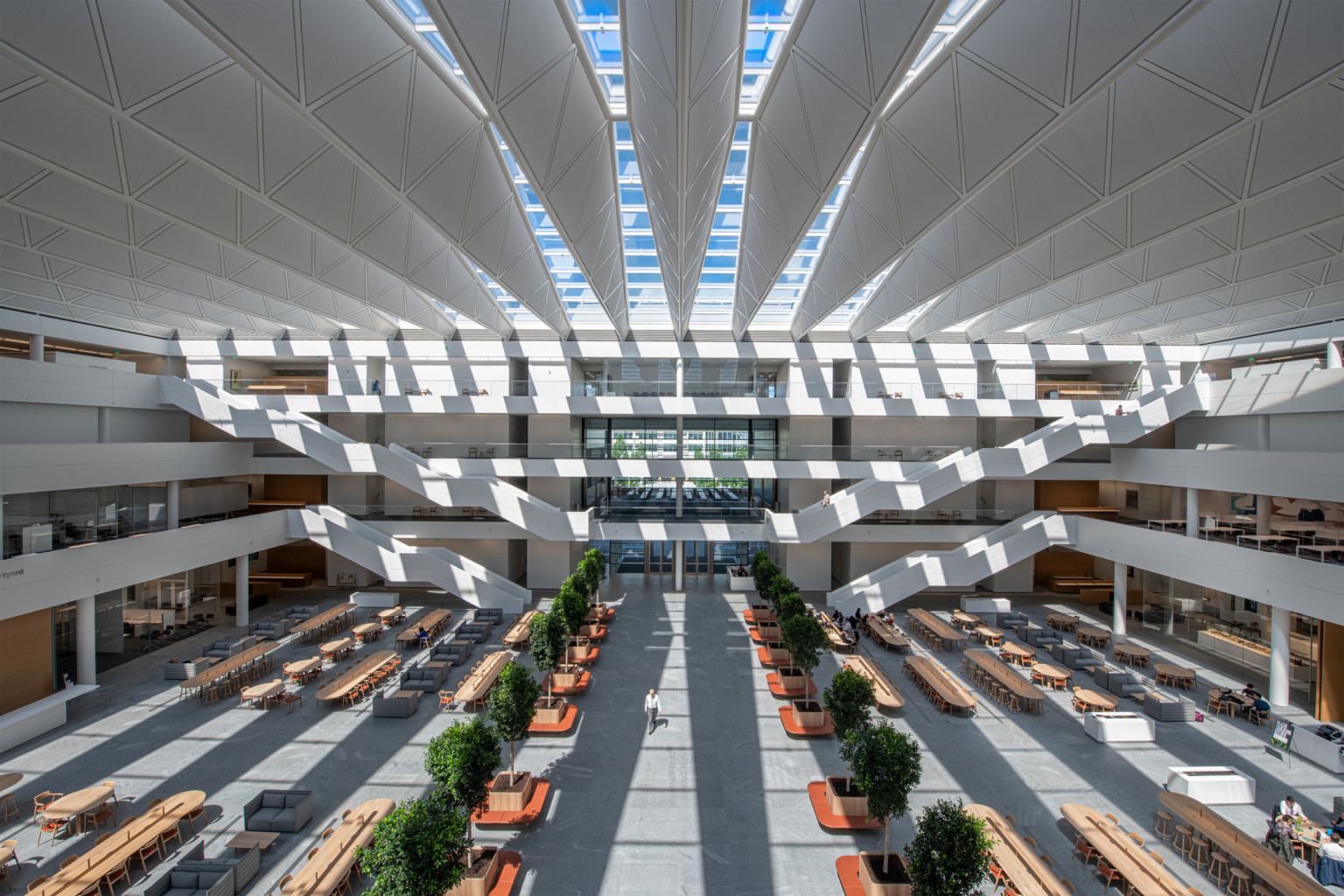 White atrium in 4 story Sheila and Eric Samson Pavilion Health Education Campus. White bannisters and walkways come to center