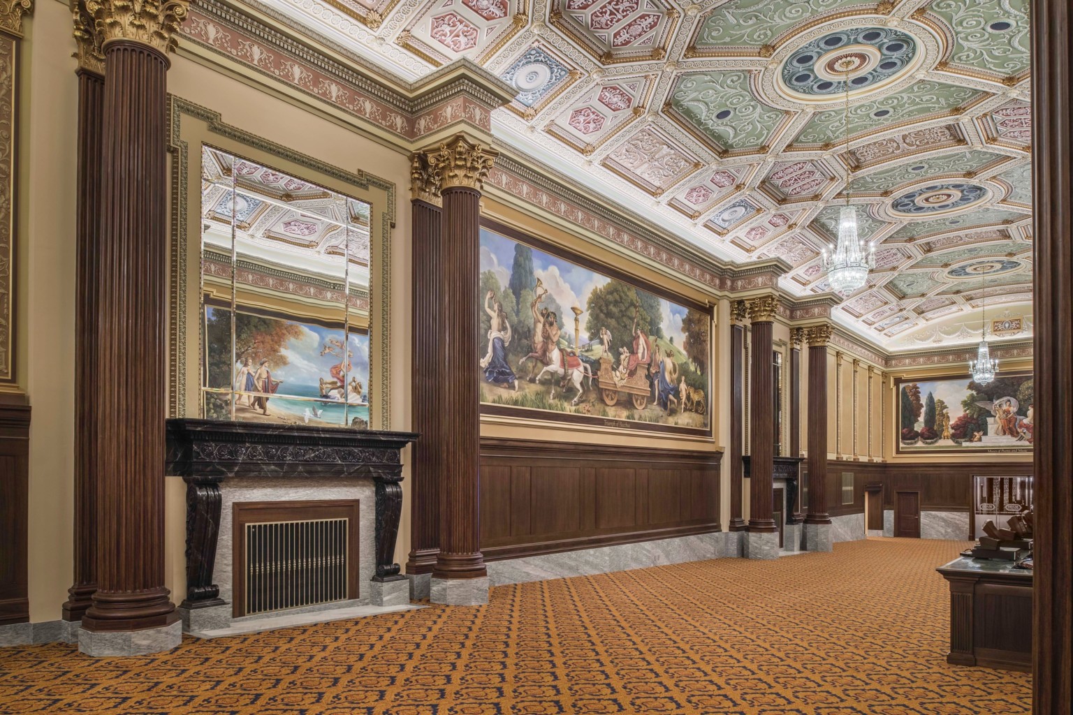 carpeted hallway with corinthian columns and colorful ceiling frescoes and large scale wall murals