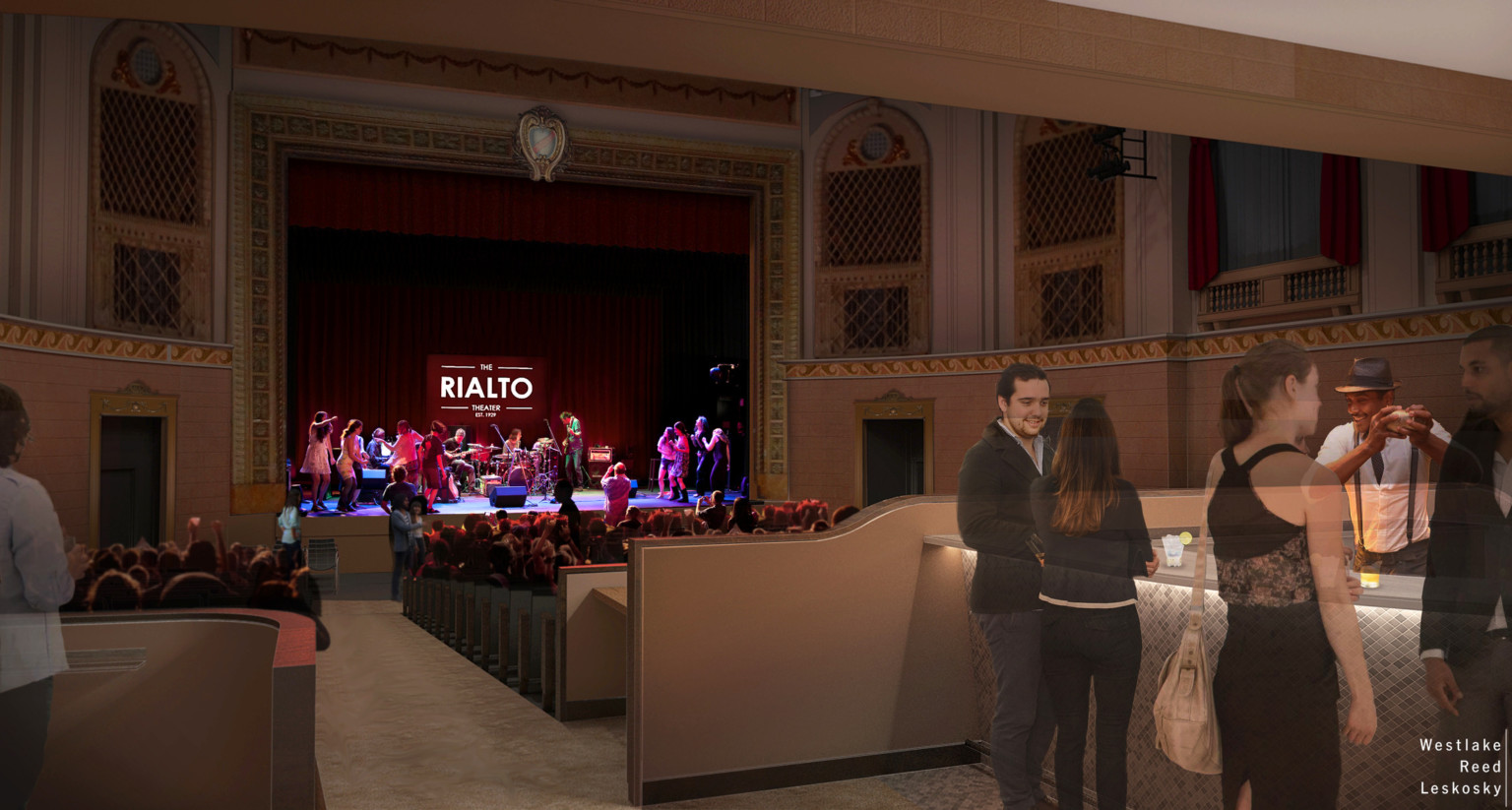 People stand at the bar in front right of image while others sit watching performance on stage of historic theater