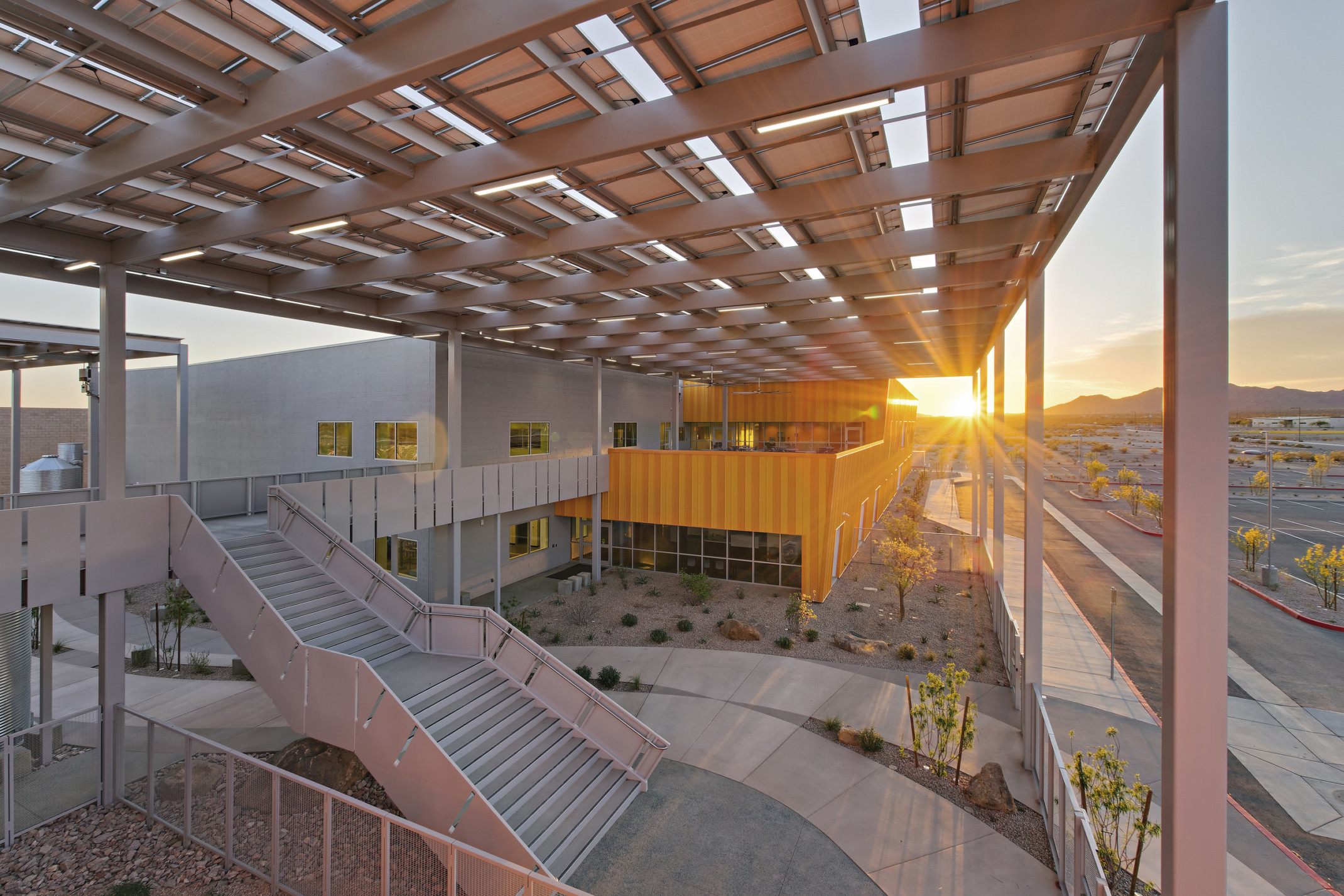 Western Maricopa Education Center (West-MEC) Southwest campus entrance. A 2 story grey and yellow building with solar canopy