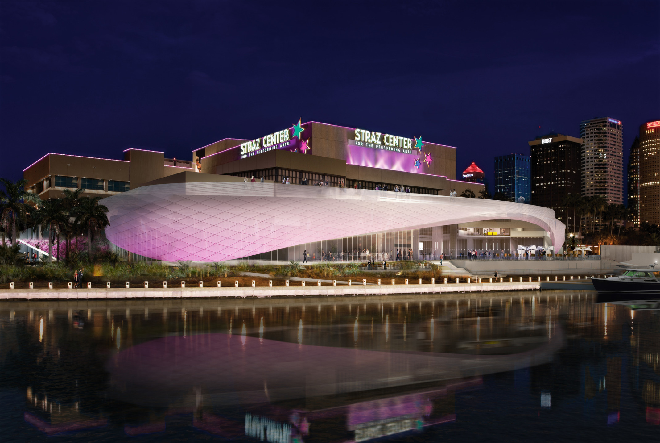 The Straz Center for the Performing Arts viewed from the river at night illuminated in purple