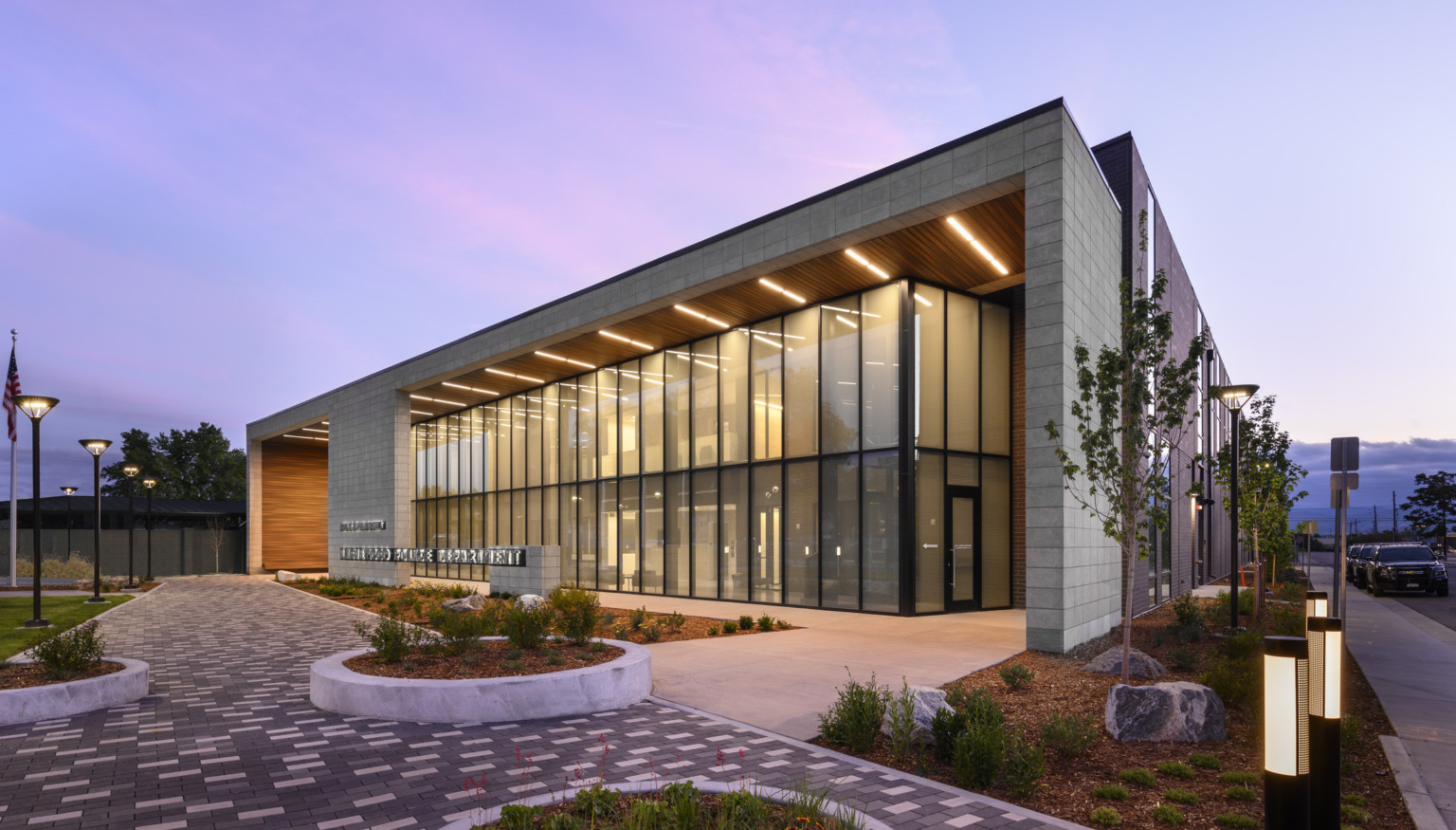 corner view of the Englewood Police Headquarters at dusk with entrance lit from above