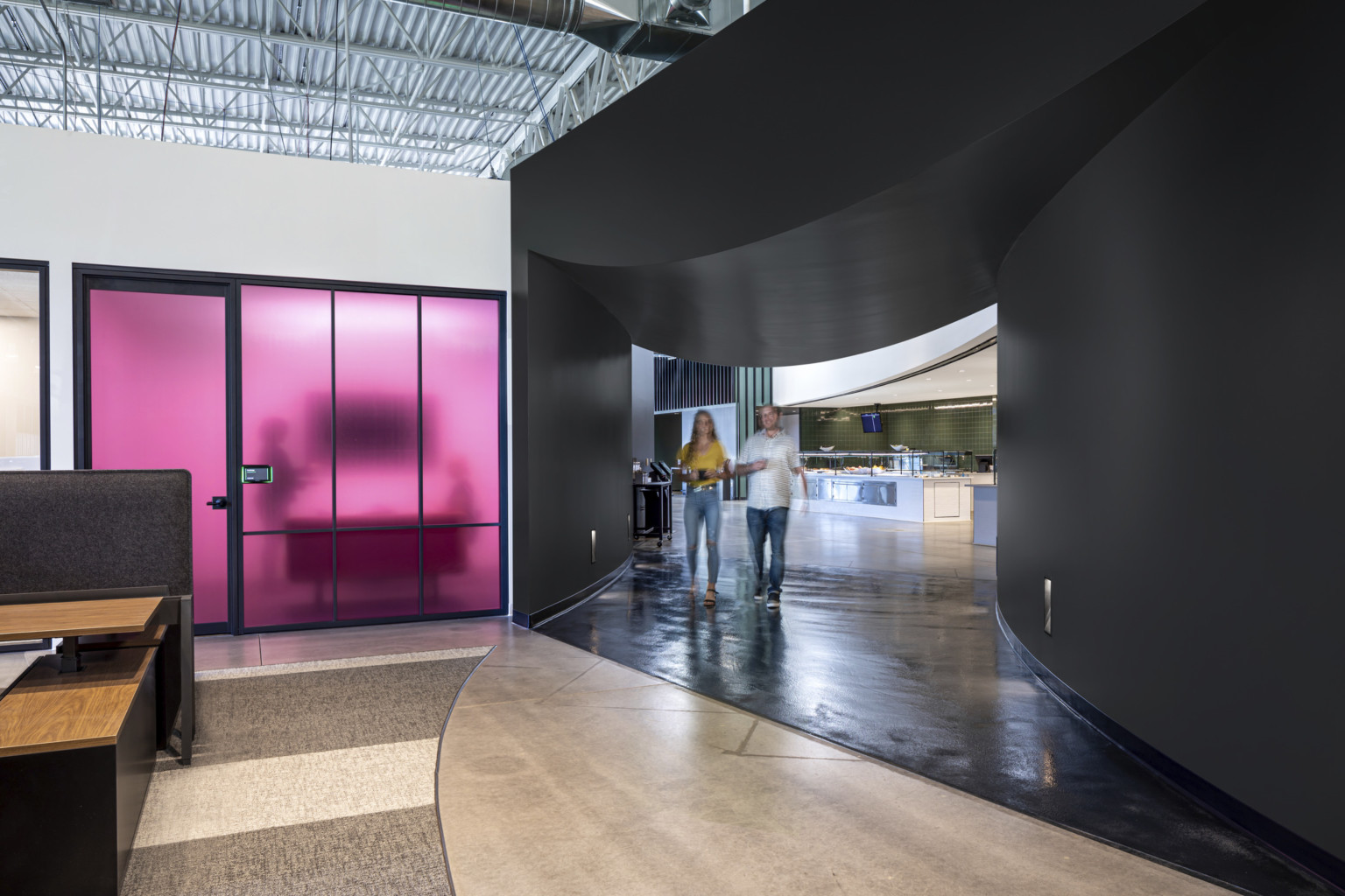 Black curved wall section with rounded dip in ceiling leading to dining. Left, translucent purple wall room below white wall