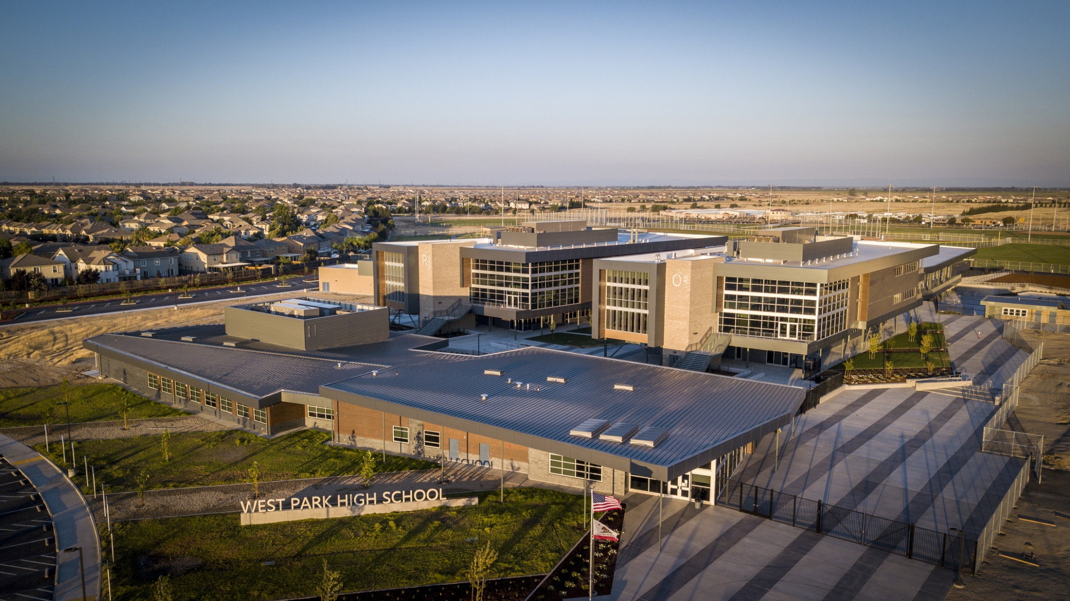 West Park High School aerial view. A brick and stone building with large windows and wrapped facade