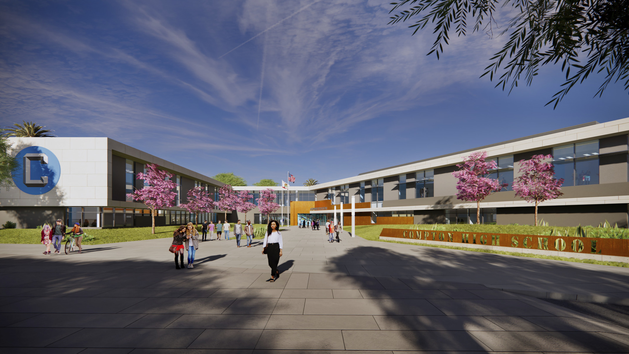 Compton High School entrance, a 2-story angled U-shaped building with white wrapping facade, blue logo on end of extension