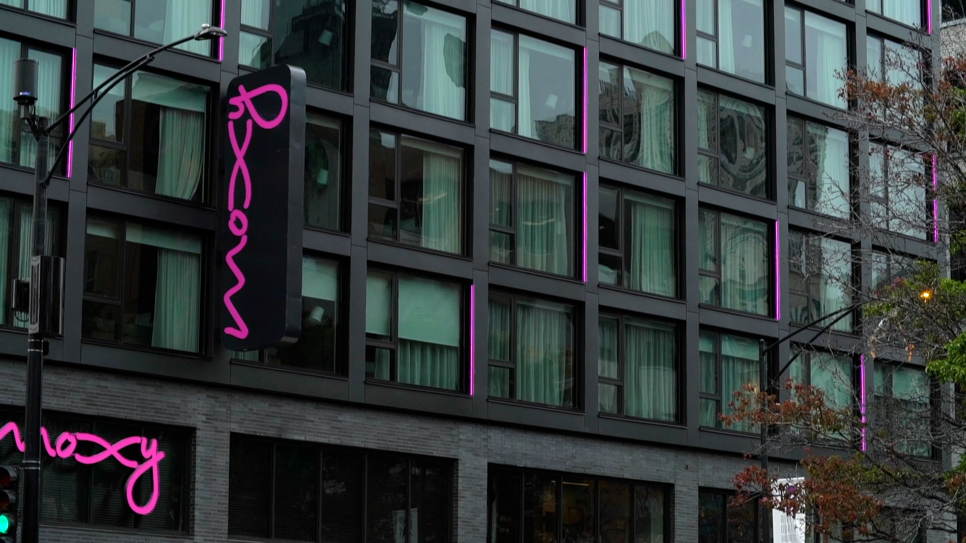 close up of a modern architecture facade with metal cladding and purple accents with Moxy written on signage