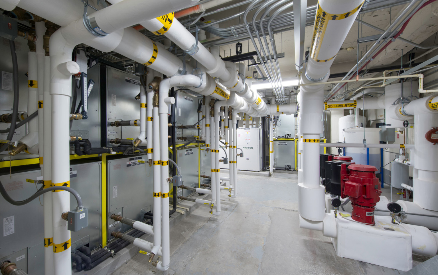Basement with white and silver exposed pipes