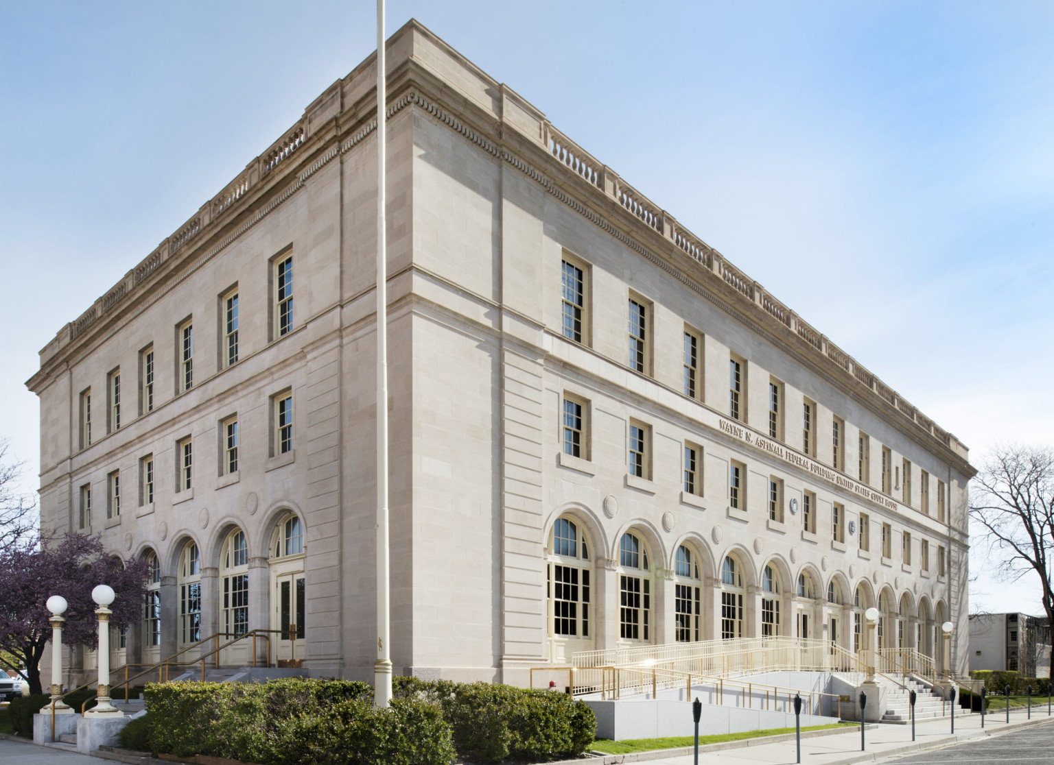 Ramp extends to the entry of a three story limestone Italian Renaissance Revival style building