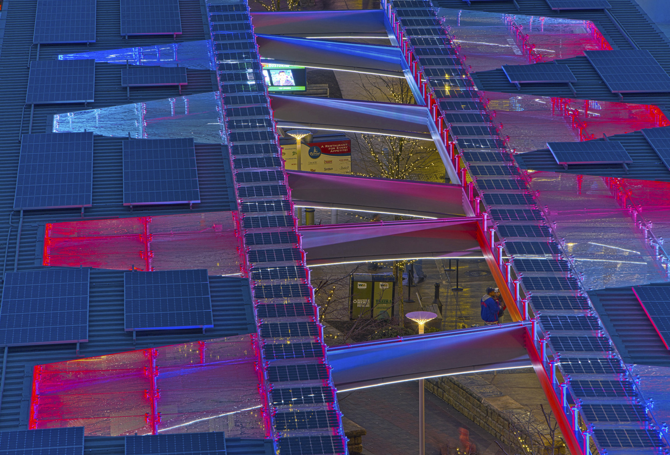 An NRG Energy Collaboration for solar integration at Patriot's Place. Red and blue LED roof panels surrounded by solar array An NRG Energy Collaboration for solar integration at Patriot's Place. Red and blue LED roof panels surrounded by solar array