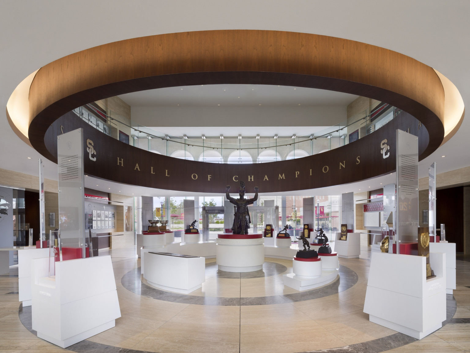 University of Southern California Heritage Hall interior, Spirit of Troy exhibit. Wood circle hangs around display and statue