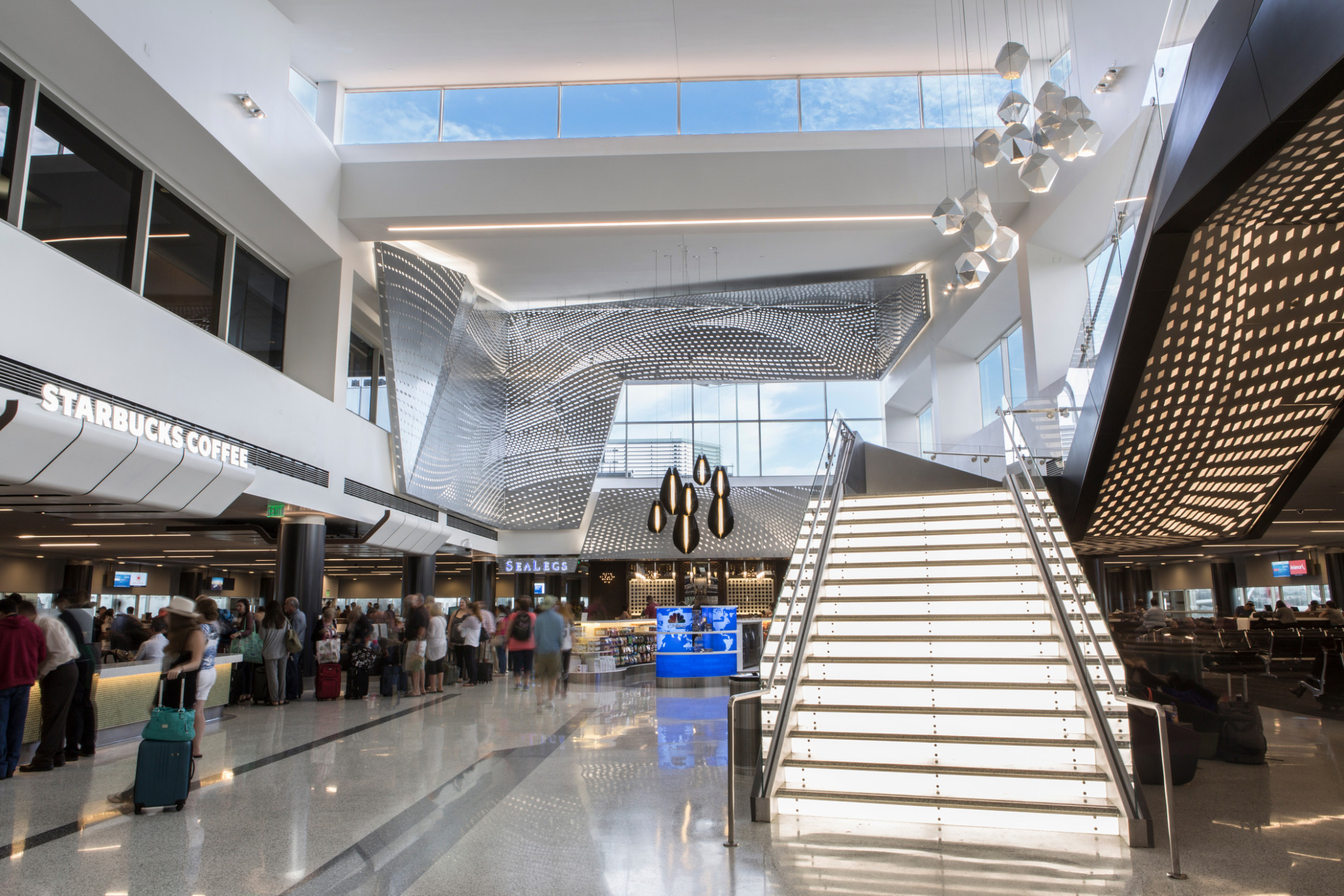 Los Angeles International Airport Terminal 2 double height interior with illuminated staircase, right, with perforated base