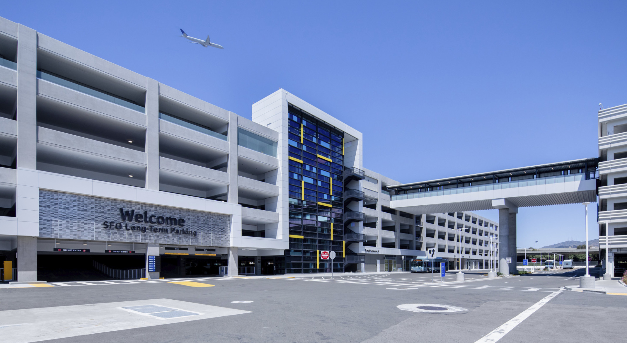 San Francisco International Airport Long Term Parking Garage, 6 stories with glass facade center and stairs. Entrance to left