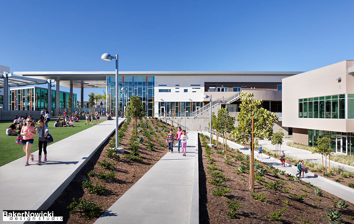 multi level pathways in courtyard of Design39 campus. White building with multicolor glass in double height window section