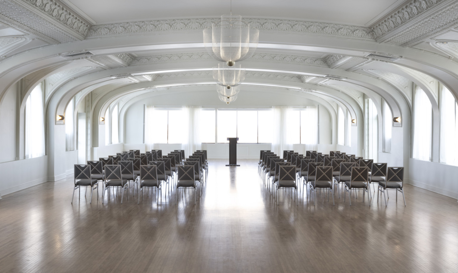 ballroom with white arched ceilings