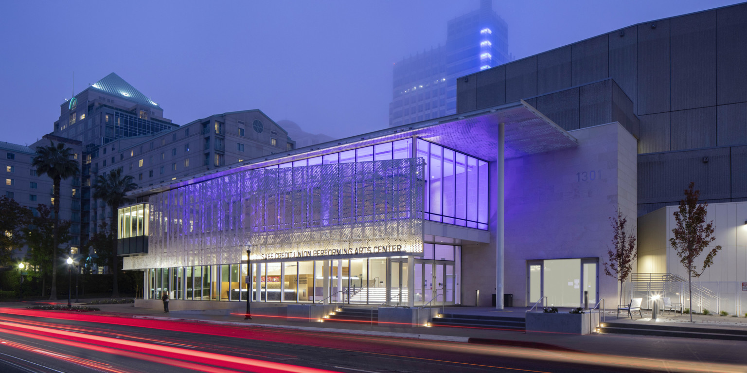SAFE Credit Union Performing Arts Center in Sacramento viewed from across the street , lit from within by purple lights
