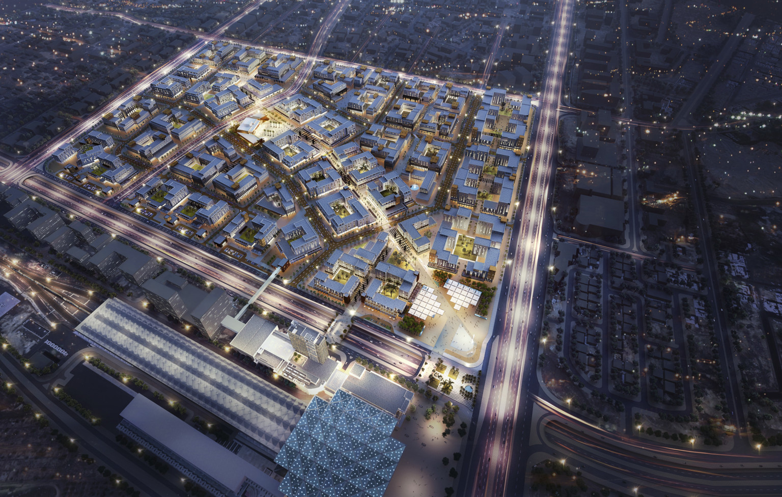 gridded master plan with vehicular street divisions and large commercial buildings with bright lights against dark sky