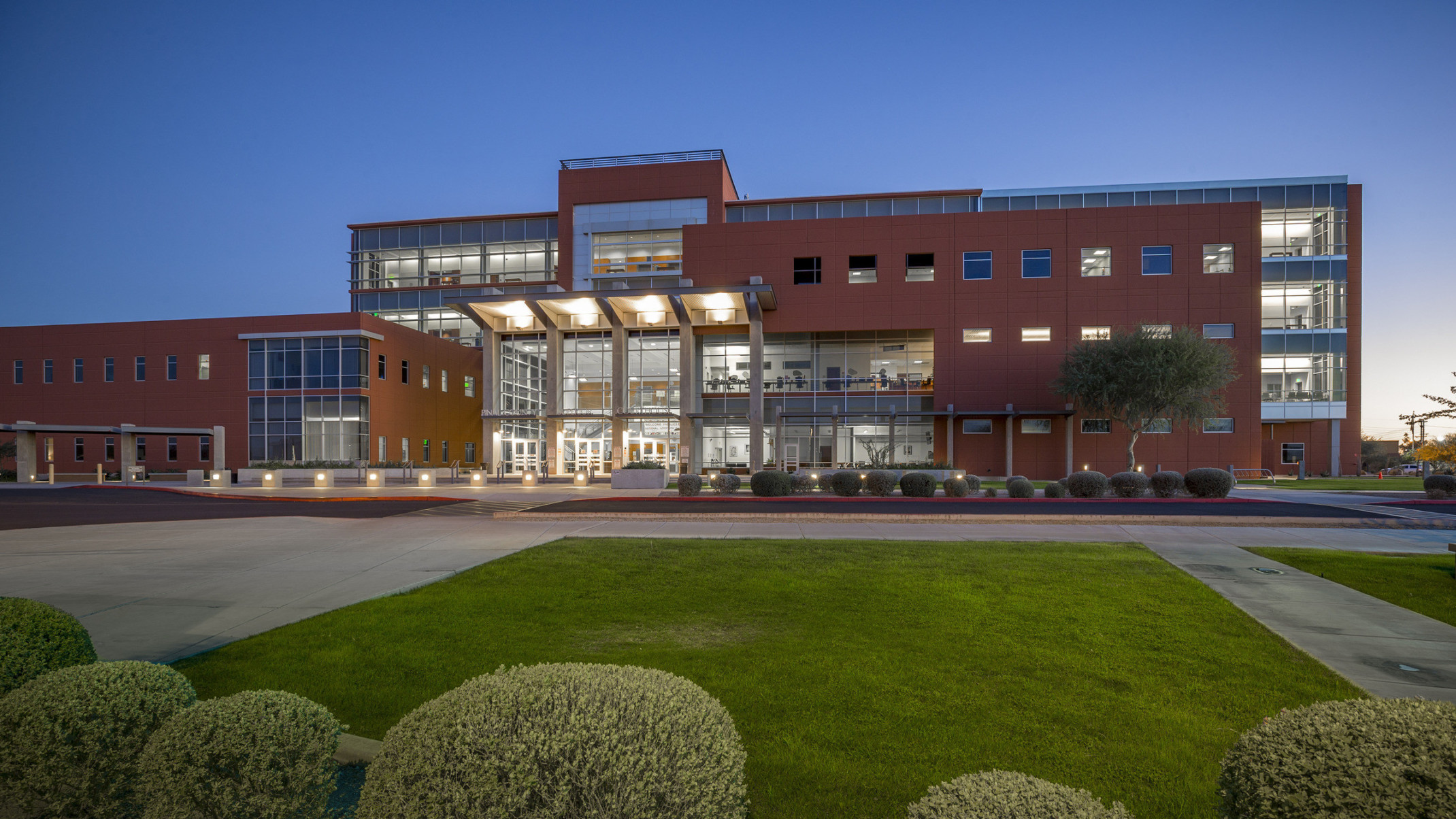 Evening view overlooking lawn of Pinal County Courts building with large window features