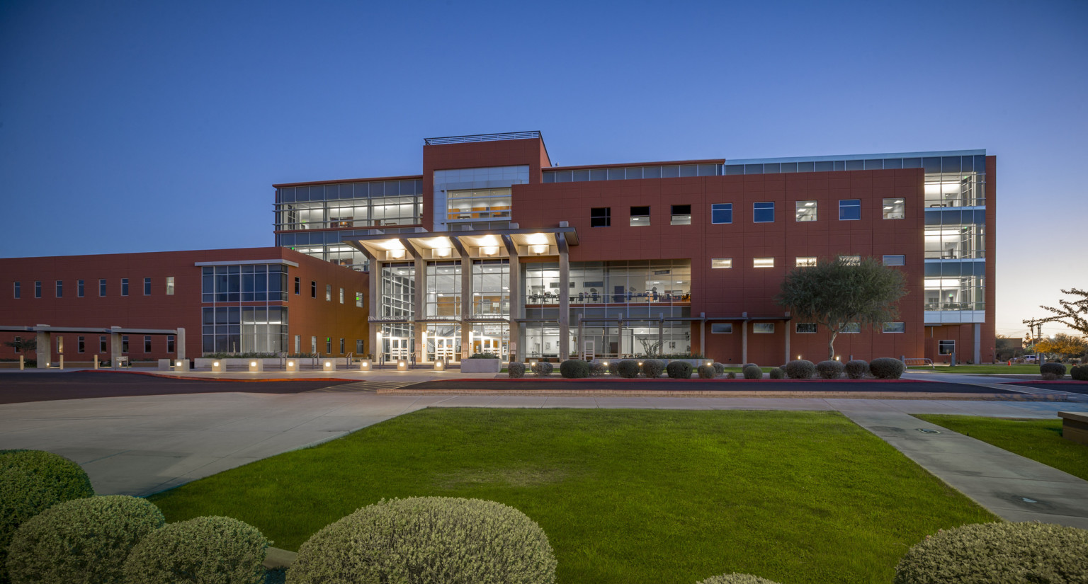 Evening view overlooking lawn of Pinal County Courts building with large window features Evening view overlooking lawn of Pinal County Courts building with large window features