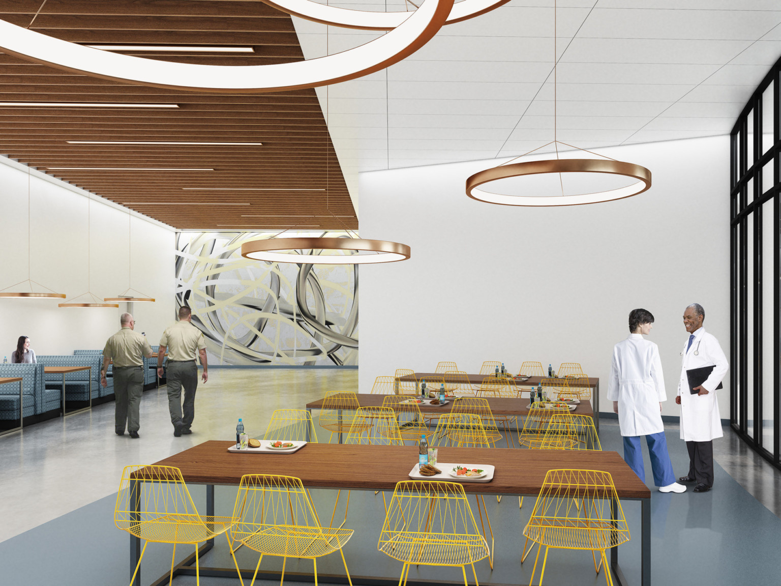 A dining area with long tables, booths, and chairs. Round lights hang overhead, as well as a wood panel drop ceiling detail