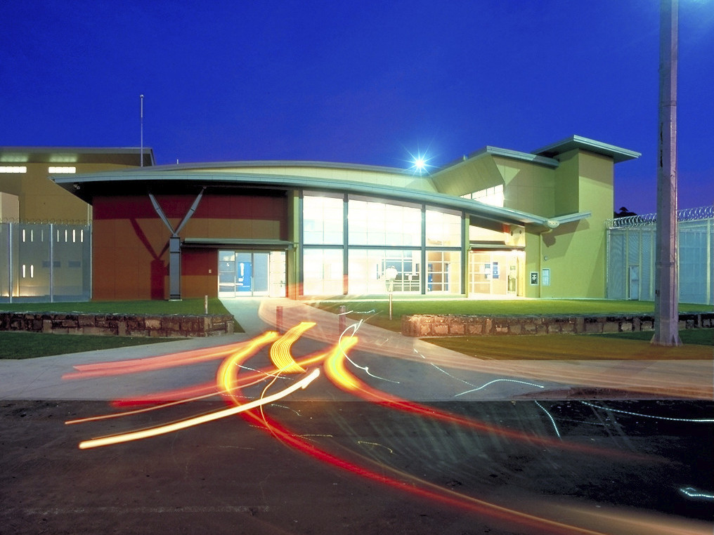 Front entry to the building illuminated at night