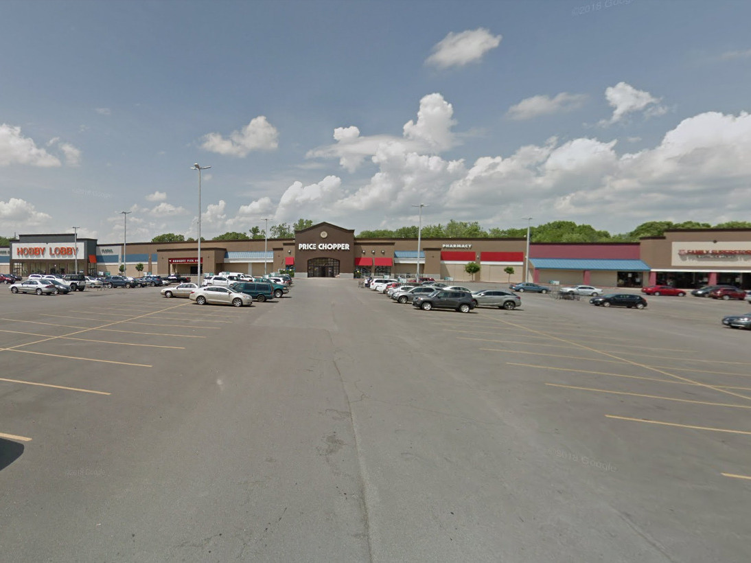 a parking lot in front of a strip mall of big box stores