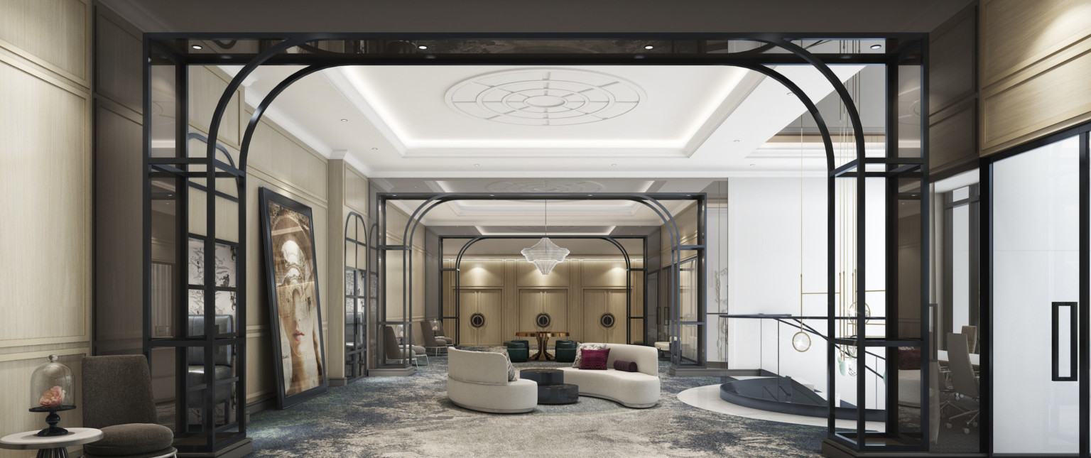 Seating area at the top of a spiral staircase with two rounded couches under molded ceiling. Metal arches separate spaces