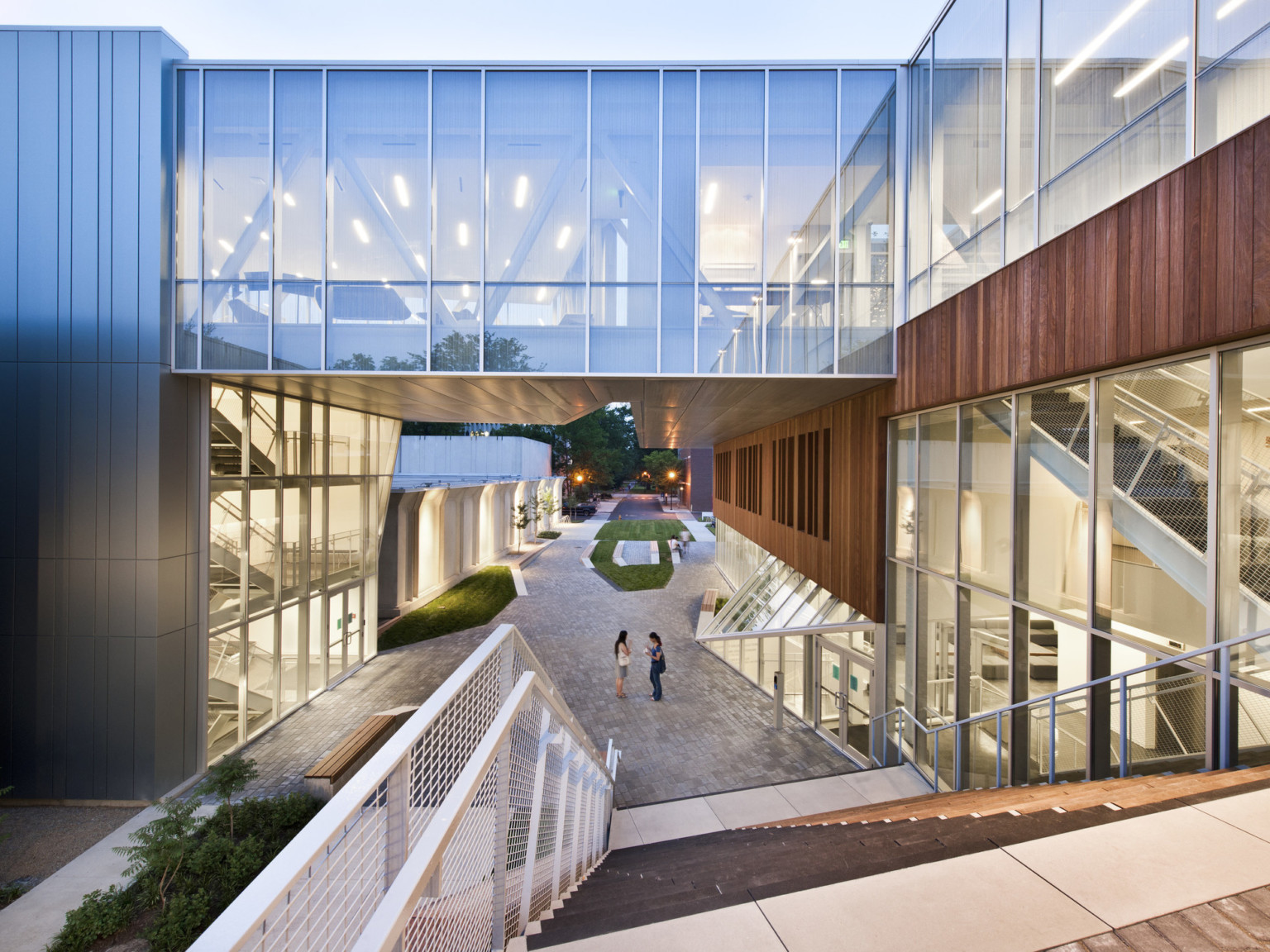 Campus plaza at Oberlin College seen from top of the stairs looking down to walkway under 4th floor skywalk