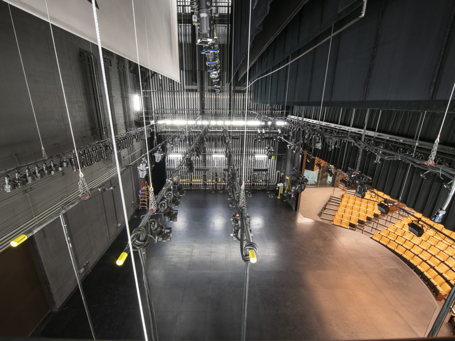 Stage viewed from above showing the lighting, curtains, and ropes at the side of the stage to control these systems