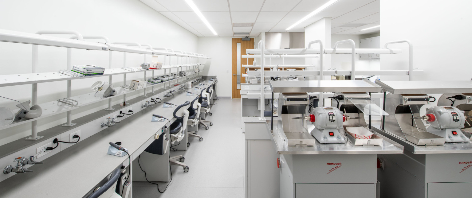 Learning lab, a grey table lines the left wall with equipment at each station. Larger tools are at stations to the right.