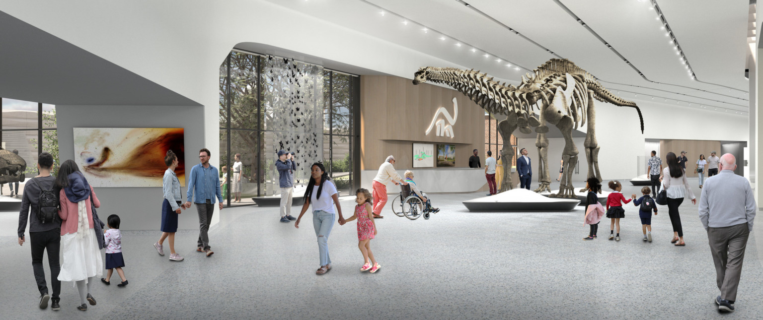 Rendering of large hall with reception desk to the back below illuminated logo and gallery space to either side