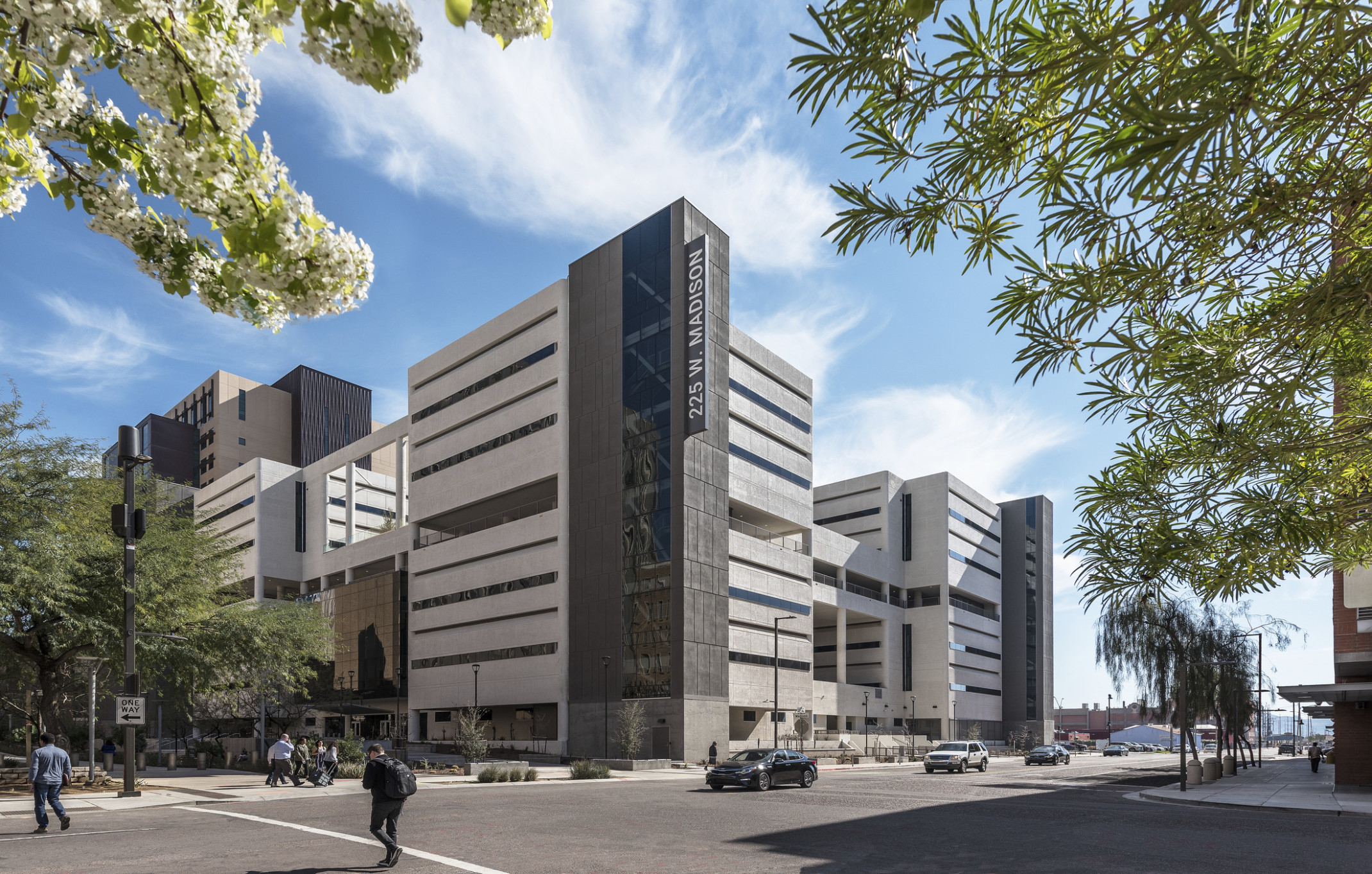 mid rise commercial office building at a street corner with active pedestrian and vehicular traffic