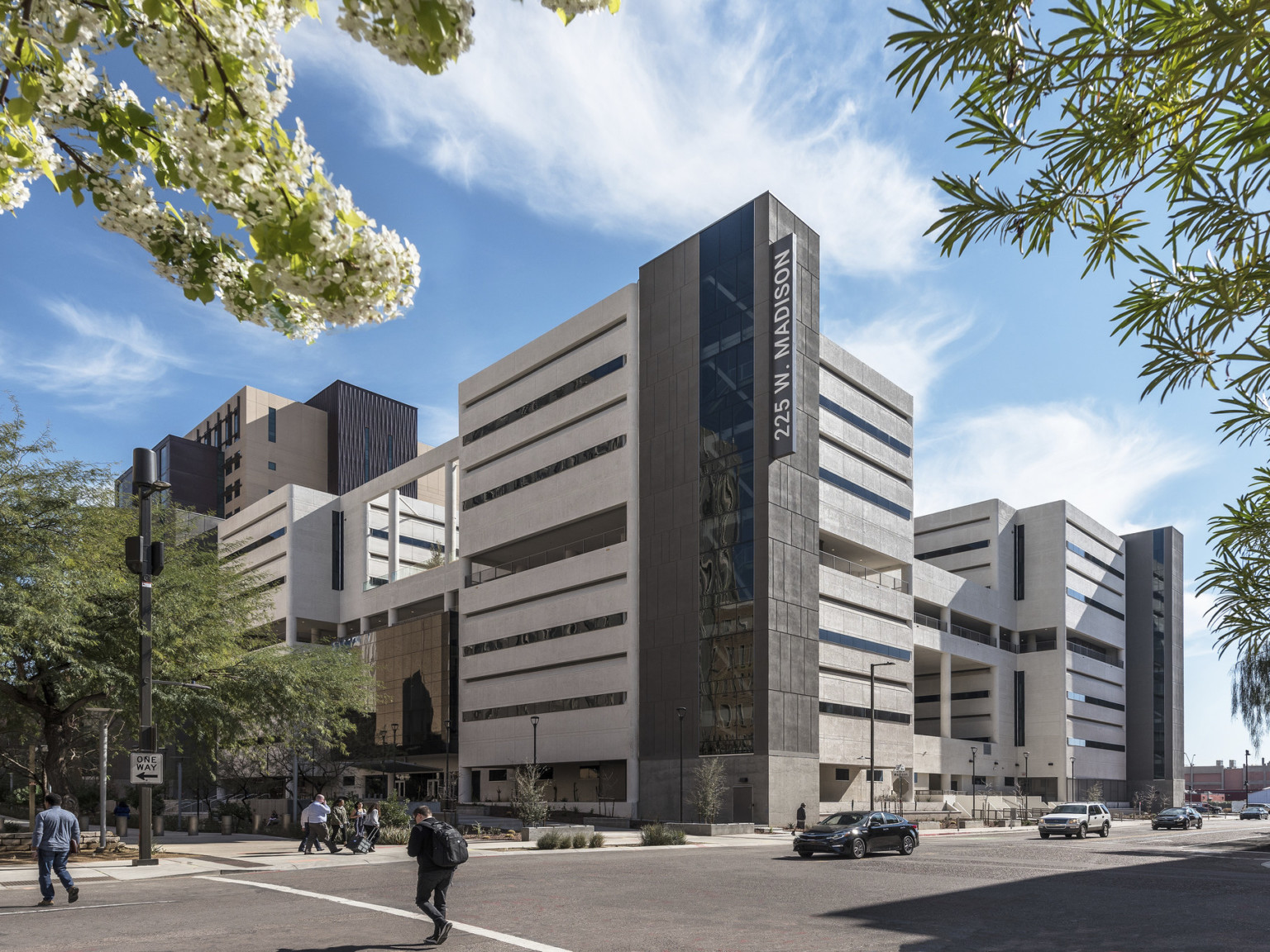 mid rise commercial office building at a street corner with active pedestrian and vehicular traffic