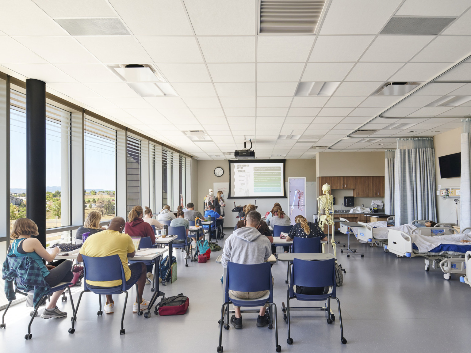 nursing teaching lab with acoustic tile ceiling bed bays and sheet flooring