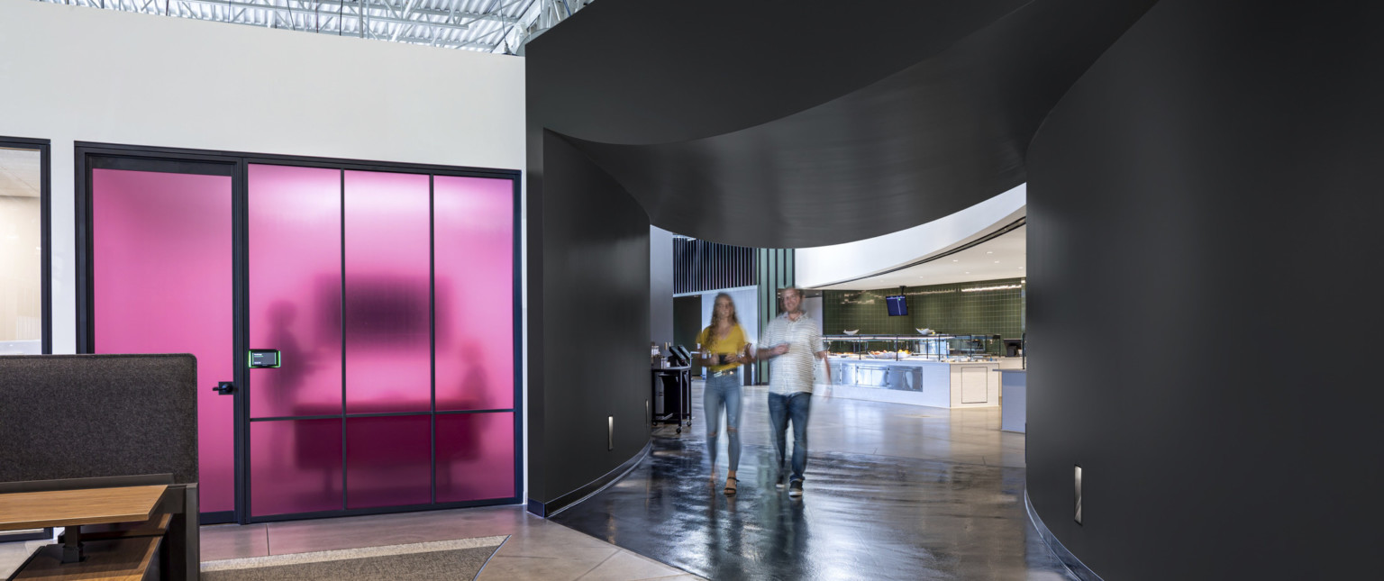 Black curved wall section with rounded dip in ceiling leading to dining. Left, translucent purple wall room below white wall