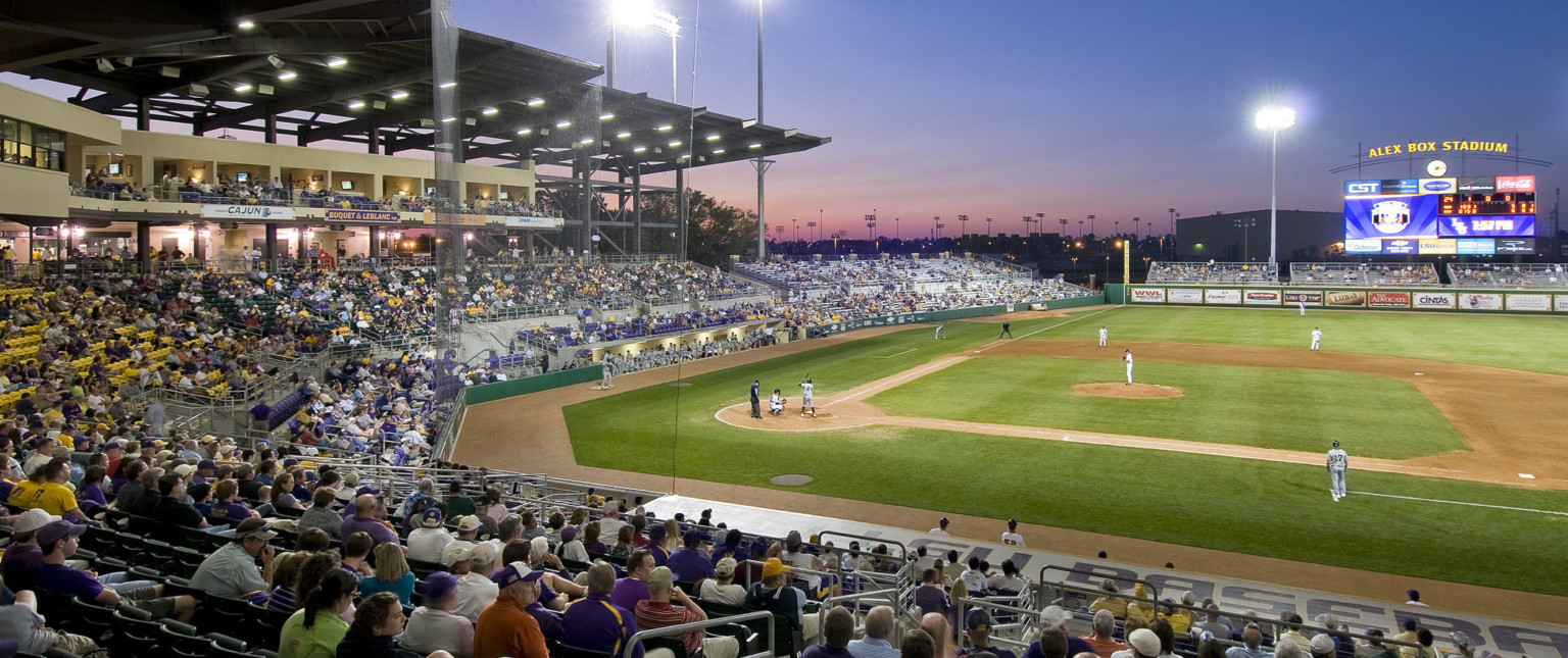 View from first base side across field. Lower deck seating behind left field with jumbotron display and stadium light above