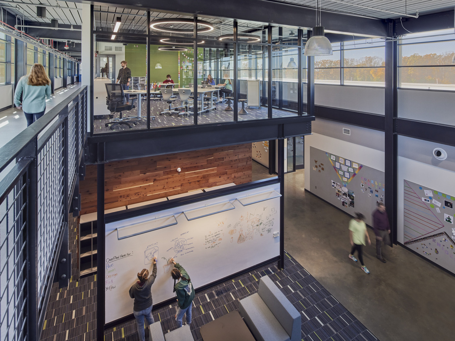 industrial tech classroom next to an open collaboration area where a second level overlooks