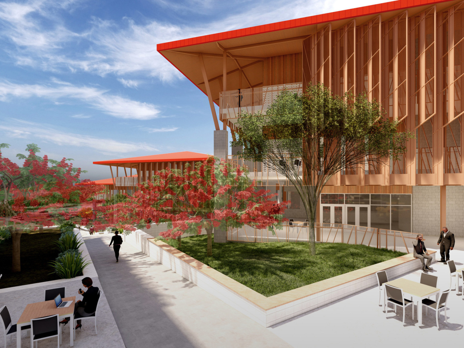 Courtyard with seating along stone pathway, trees and green space. Back, stone building with red canopy roof and wood accents