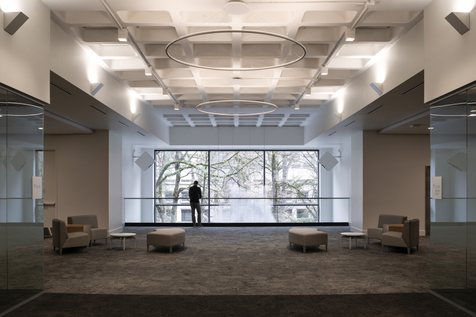 a mezzanine overlooking a double height glass volume at the portland building