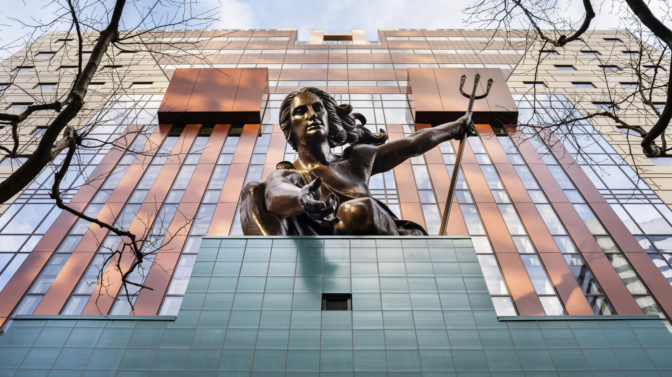 Looking up at the copper repoussé statue of Portlandia above the teal tiled entryway of The Portland Building