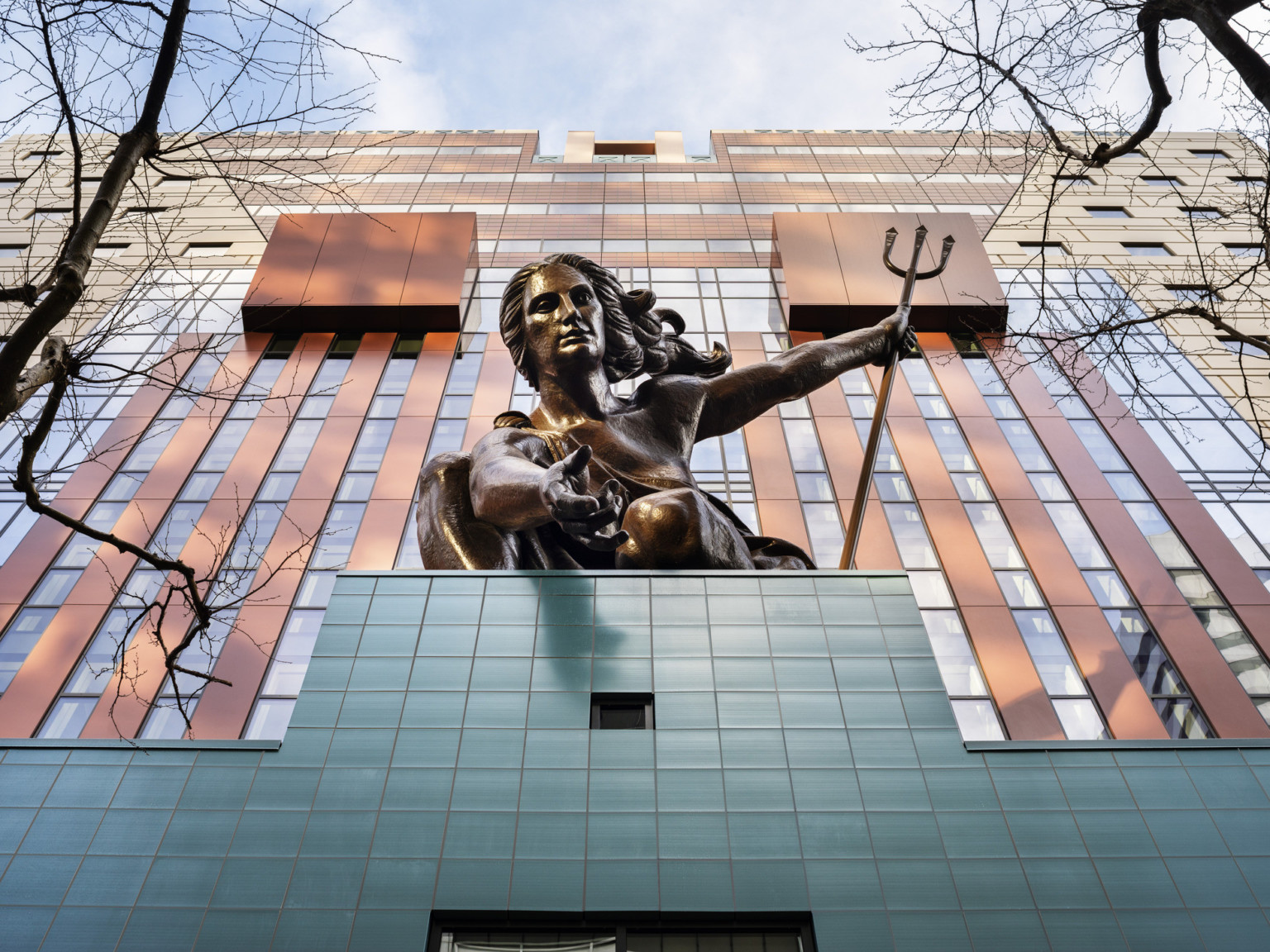 Looking up at the copper repoussé statue of Portlandia above the teal tiled entryway of The Portland Building