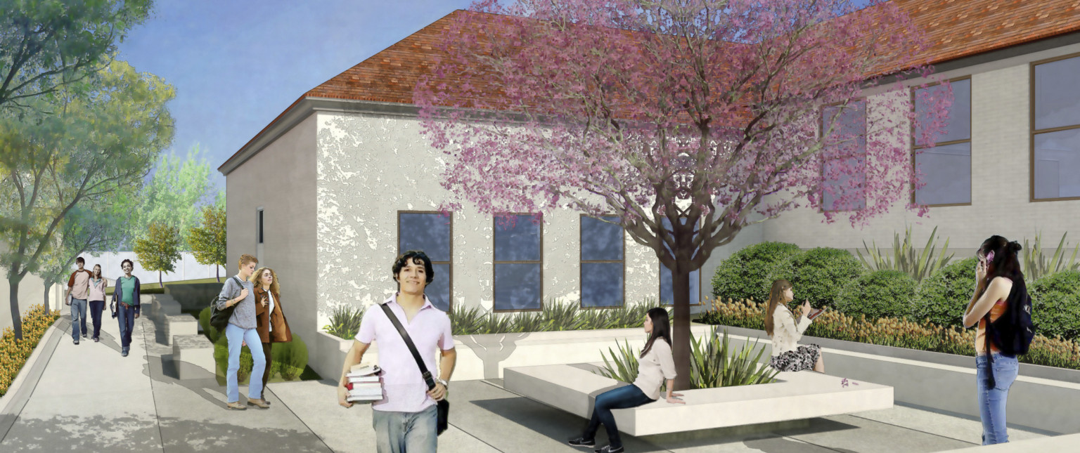 Large courtyard alcove lined with plants and a square concrete tree seat at center. White walls of single story with red roof