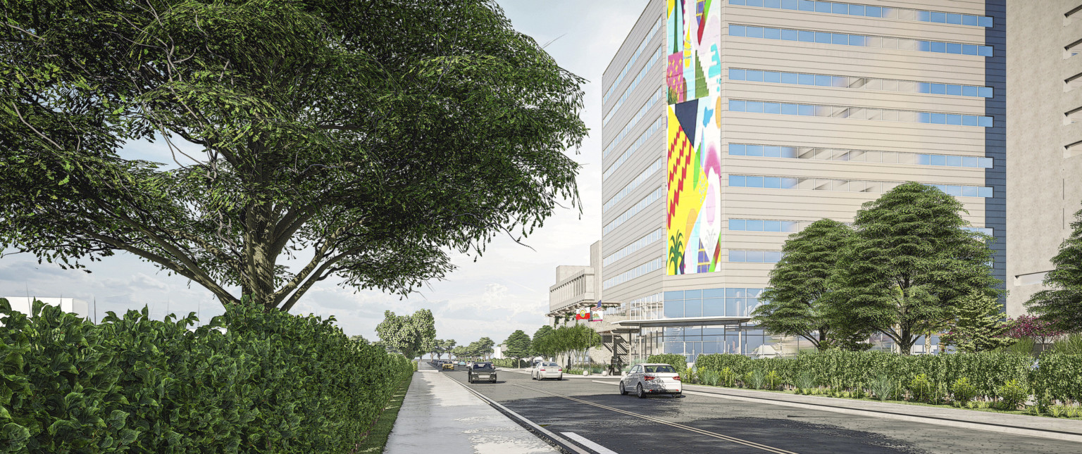 View of building exterior from across the street. Corner of building is a flat surface with 8 story mural above lobby windows