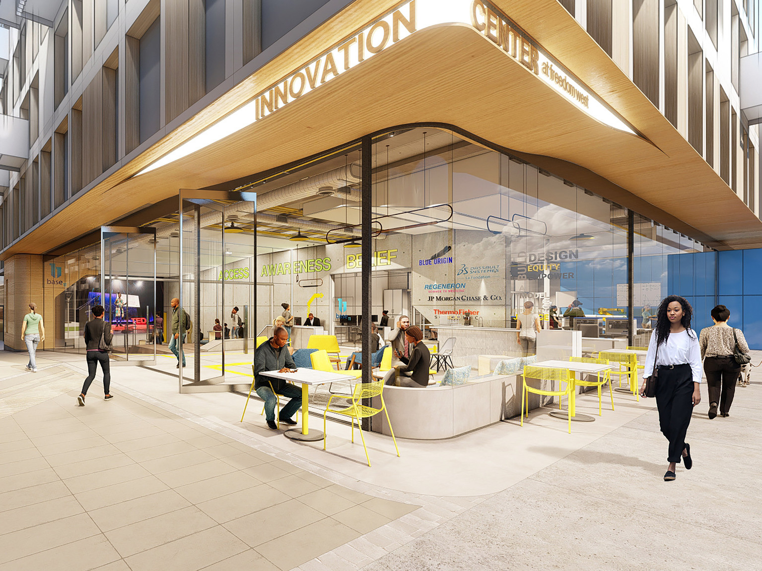 Floor to ceiling windows on ground level. Outdoor seating under wood overhang with recessed lit sign for Innovation Center