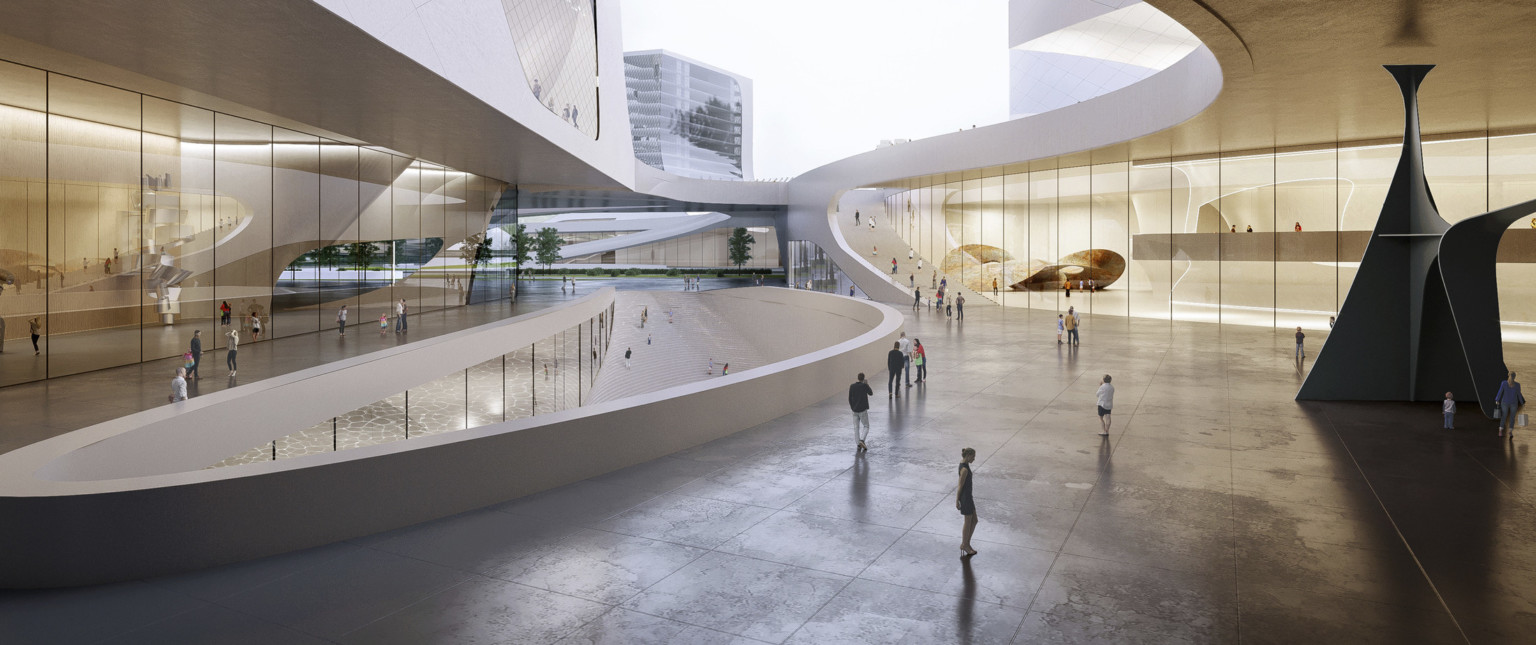 Spacious plaza with walkway on either side of descending ramp, surrounded by lobby windows and white overhang accessed by ramp