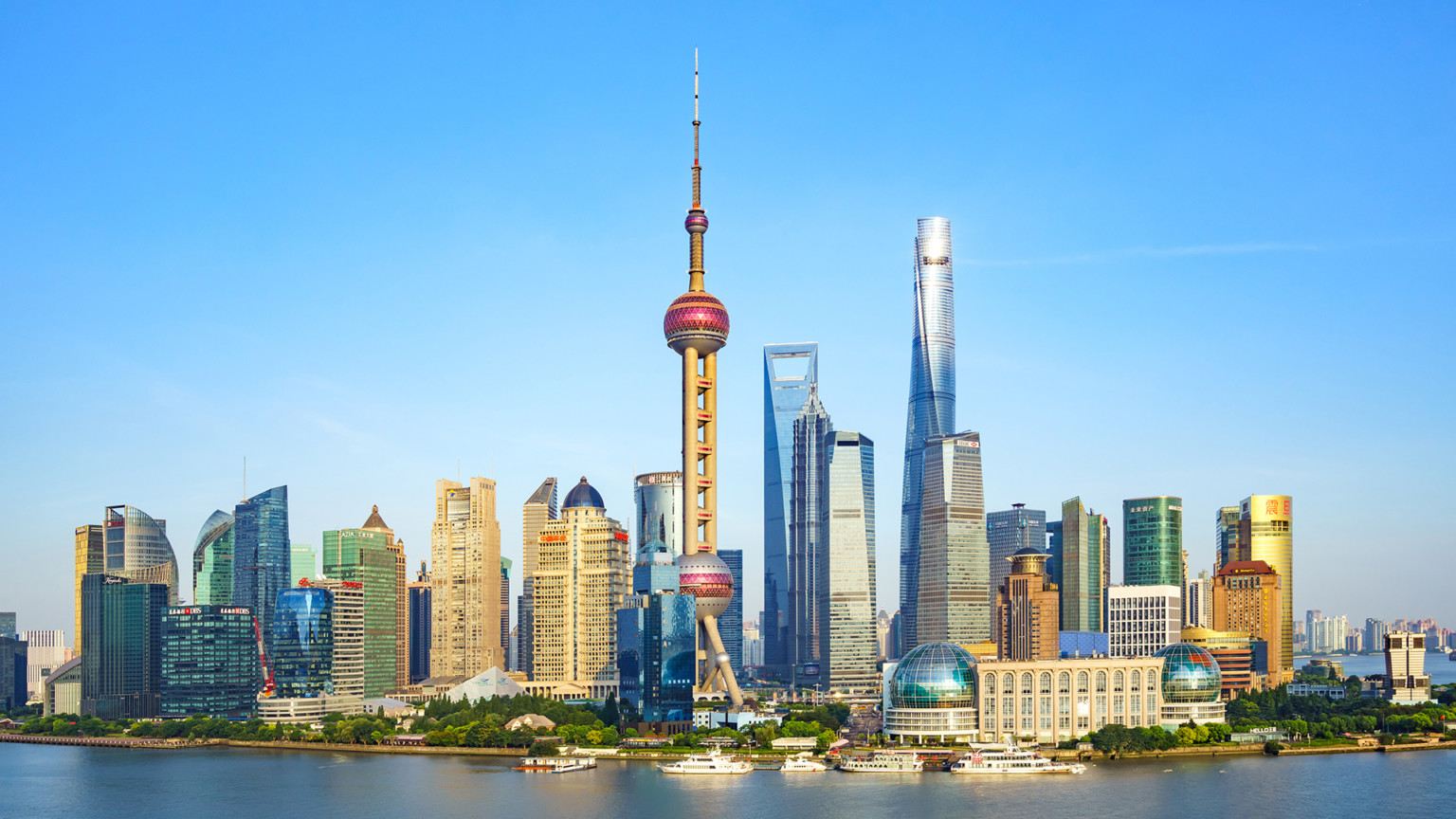 The Shanghai skyline with the oriental pearl tv tower behind the bund waterfront of the Huangpu River