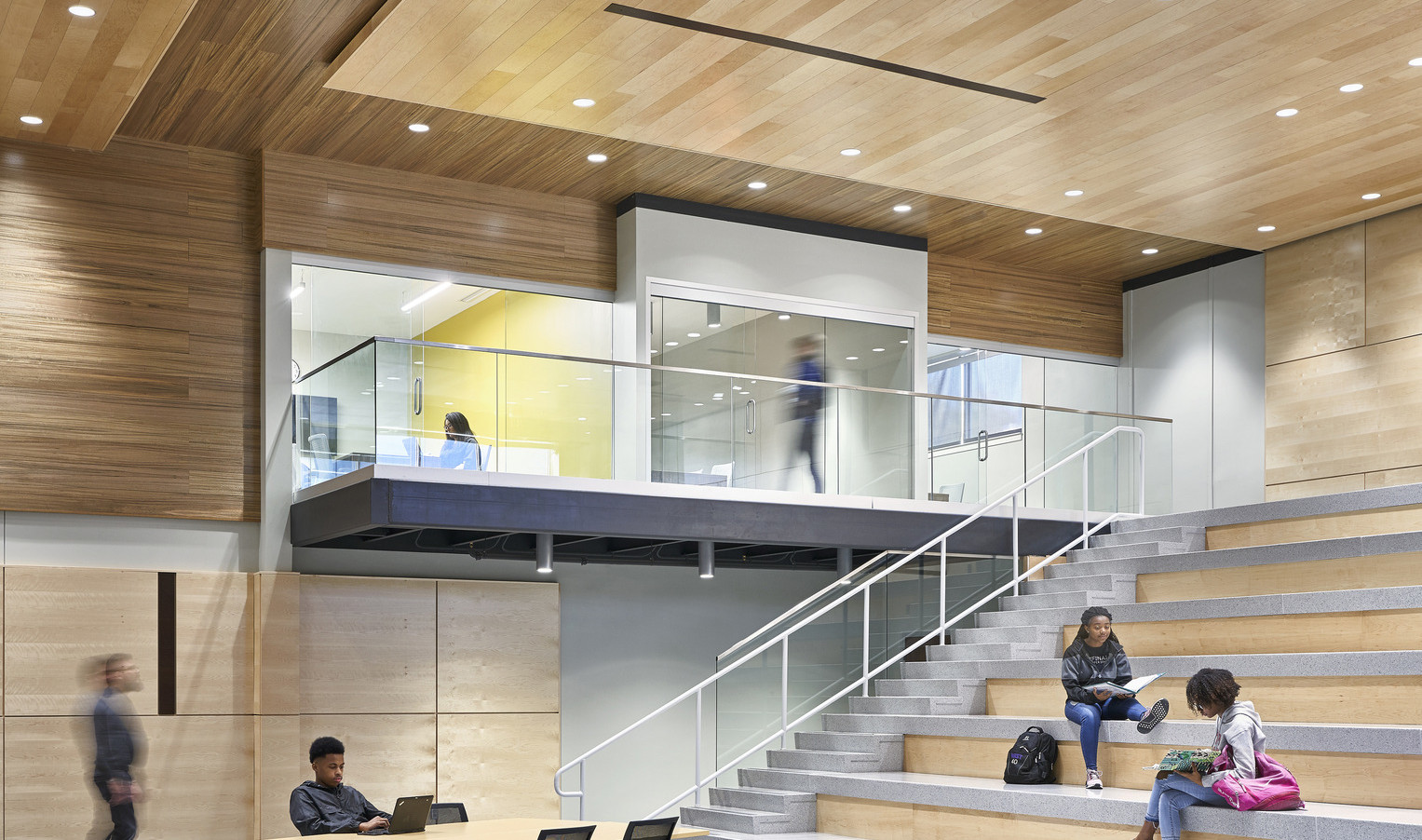 Topeka Center for Advanced Learning & Careers double height interior wood panel room with learning steps to 2nd floor hallway