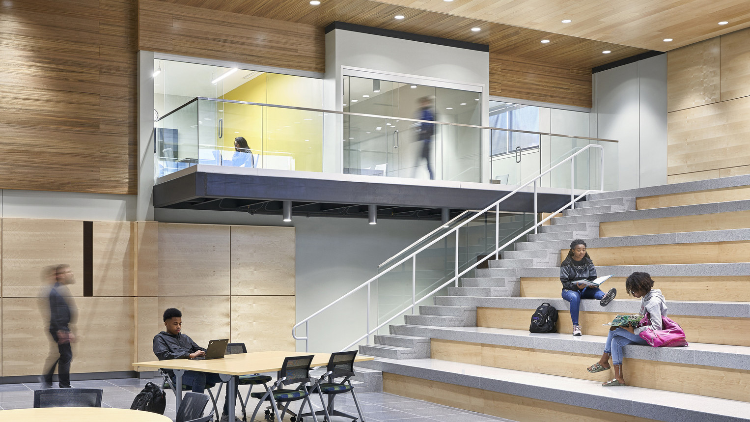 Topeka Center for Advanced Learning & Careers double height interior wood panel room with learning steps to 2nd floor hallway
